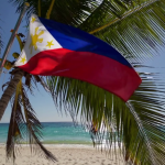 A flag from Philippines in a white sand beach