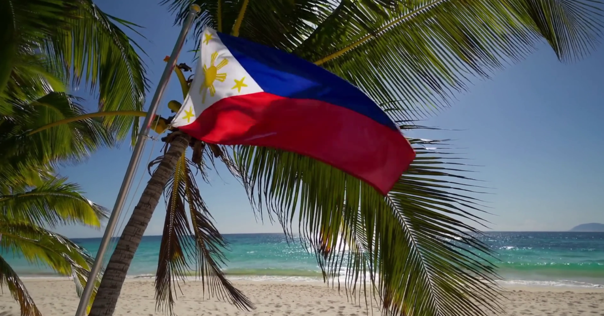 A flag from Philippines in a white sand beach